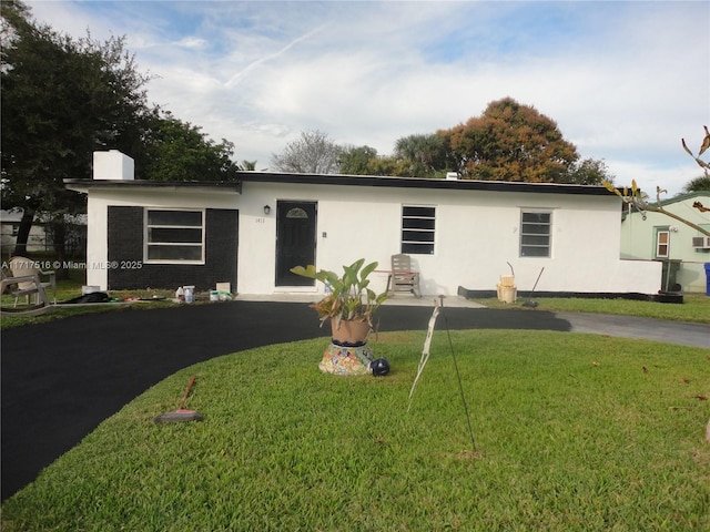 ranch-style house with a front lawn