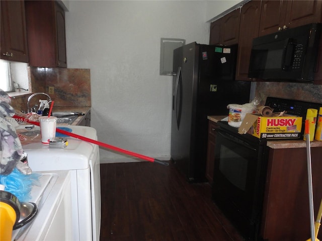 kitchen featuring sink, dark hardwood / wood-style floors, washer / dryer, dark brown cabinets, and black appliances