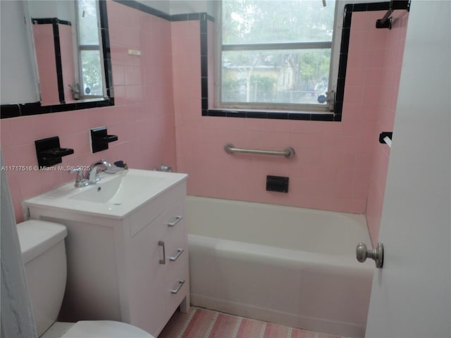 bathroom with decorative backsplash, vanity, tile walls, and toilet