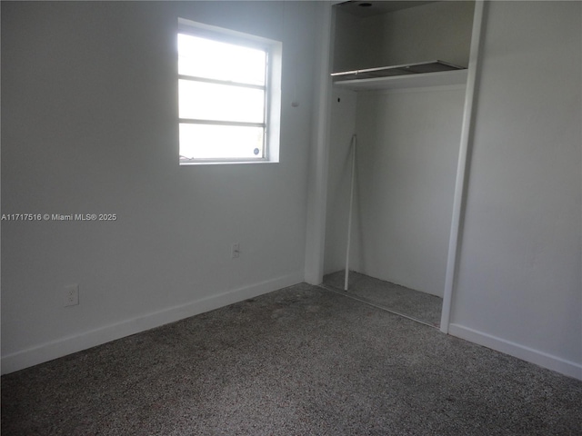 unfurnished bedroom featuring carpet and a closet