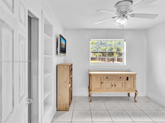 interior space with ceiling fan and light tile patterned floors