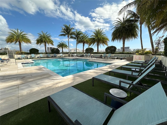 pool featuring fence and a patio