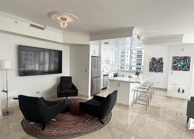 living room featuring crown molding and sink