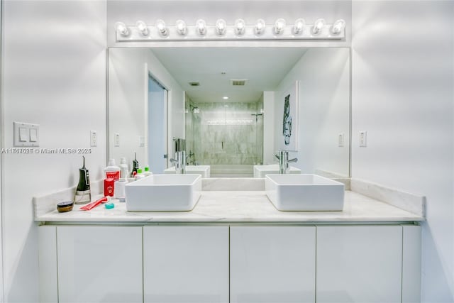 bathroom featuring vanity and a shower with shower door