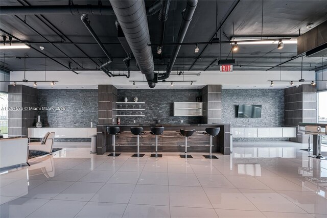 interior space with tile patterned flooring and rail lighting