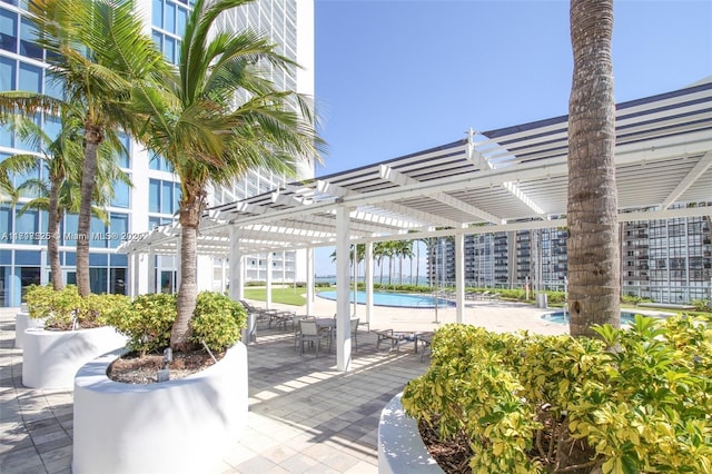 view of home's community with a patio area, a pergola, and a swimming pool