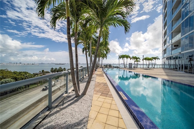 view of pool featuring a water view