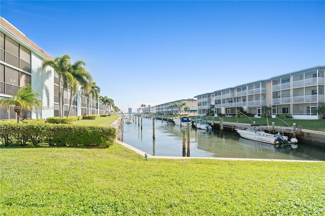 dock area featuring a yard and a water view