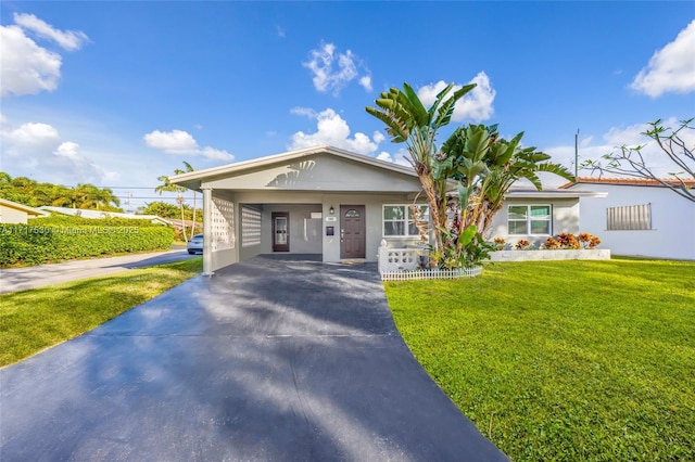 view of front of house with a front lawn and a carport