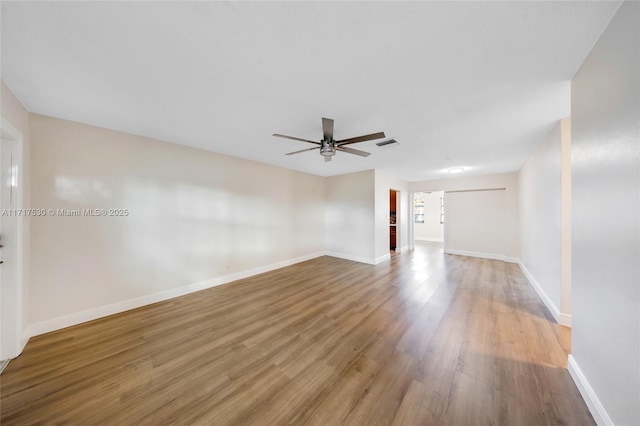 empty room with ceiling fan and hardwood / wood-style floors