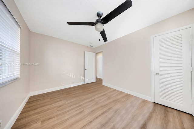 unfurnished bedroom with a closet, light hardwood / wood-style floors, and ceiling fan