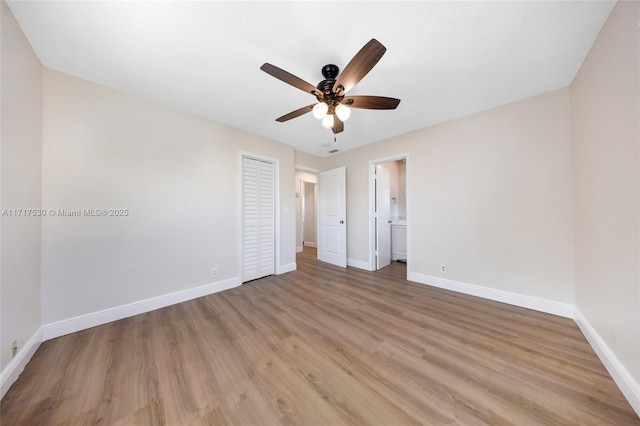 unfurnished bedroom featuring ceiling fan, a closet, ensuite bathroom, and light hardwood / wood-style flooring