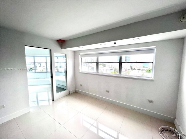 spare room featuring light tile patterned flooring