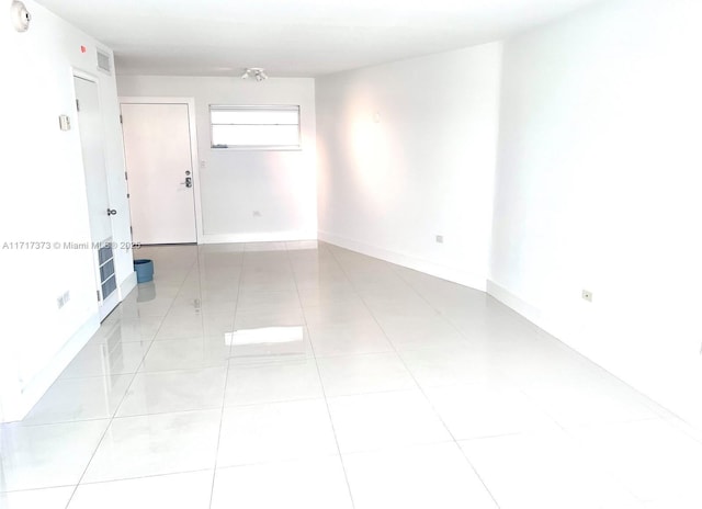 unfurnished room with light tile patterned floors