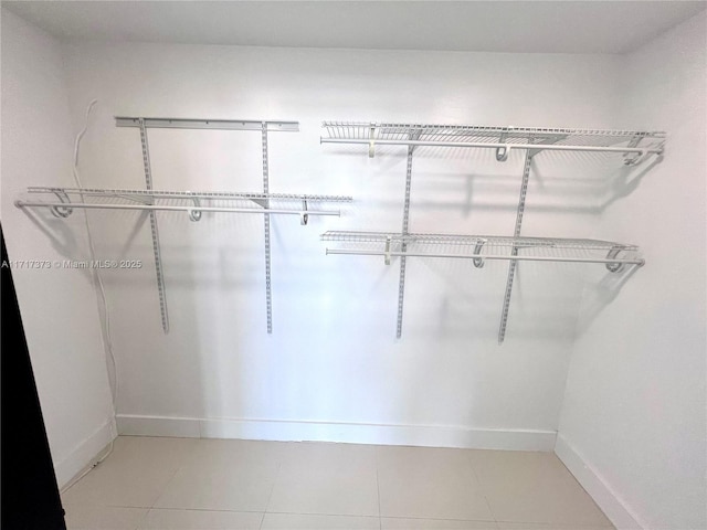 1881 Washington Ave Unit 11D, Miami Beach, FL 33139 - walk in closet featuring light tile patterned floors