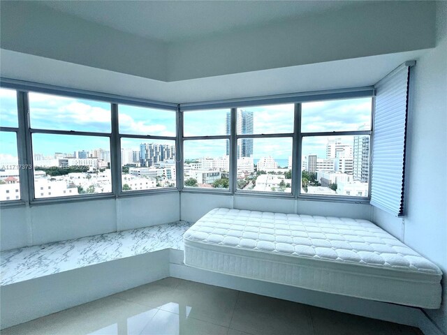 1881 Washington Ave Unit 11D, Miami Beach, FL 33139 - bedroom featuring a view of city, multiple windows, and tile patterned floors