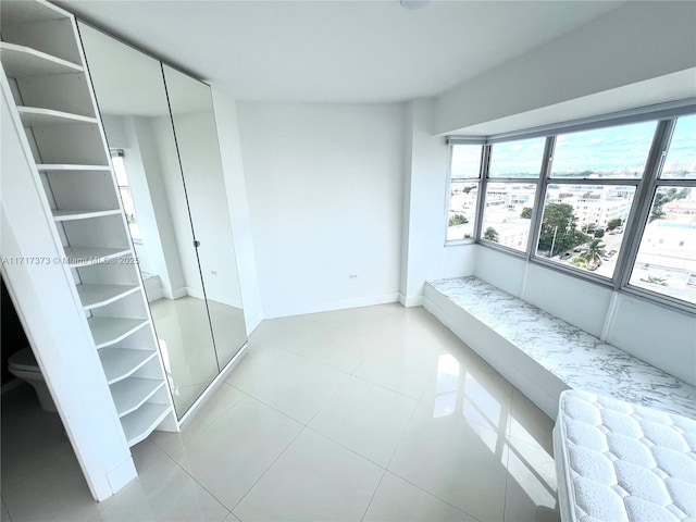 1881 Washington Ave Unit 11D, Miami Beach, FL 33139 - unfurnished bedroom featuring baseboards and tile patterned flooring