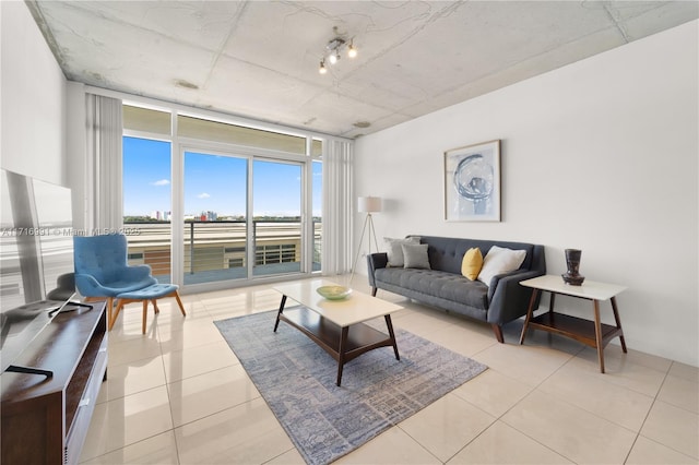 living room with a wall of windows and light tile patterned floors