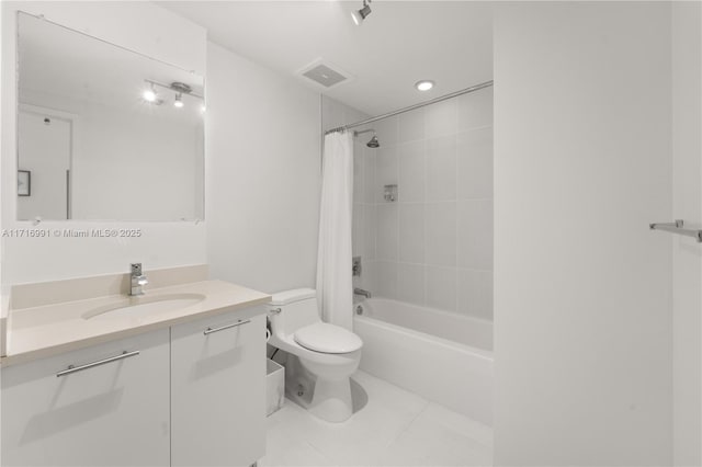 full bathroom with shower / tub combo with curtain, vanity, tile patterned flooring, and toilet