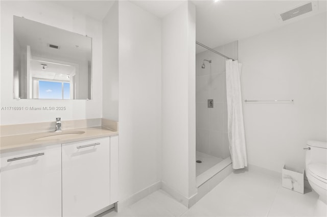 bathroom featuring tile patterned floors, vanity, toilet, and a shower with shower curtain