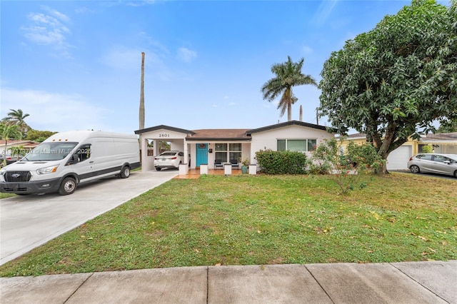 ranch-style house featuring a front lawn and a carport