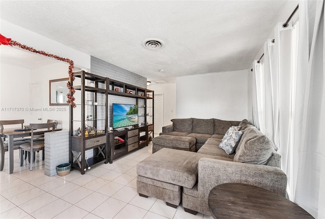 tiled living room with a textured ceiling