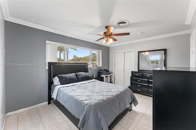 tiled bedroom with ceiling fan, ornamental molding, and a closet