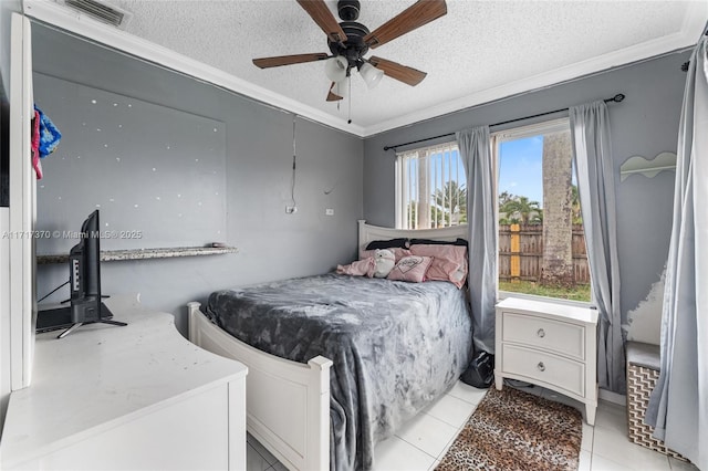 bedroom featuring ceiling fan, light tile patterned floors, a textured ceiling, and multiple windows