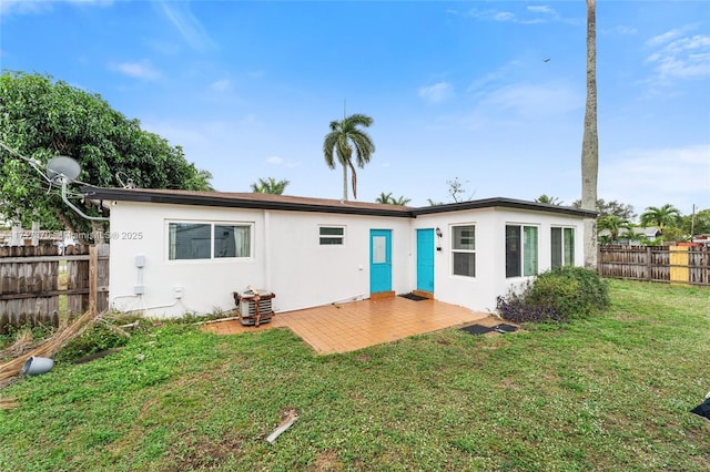 rear view of property with a lawn