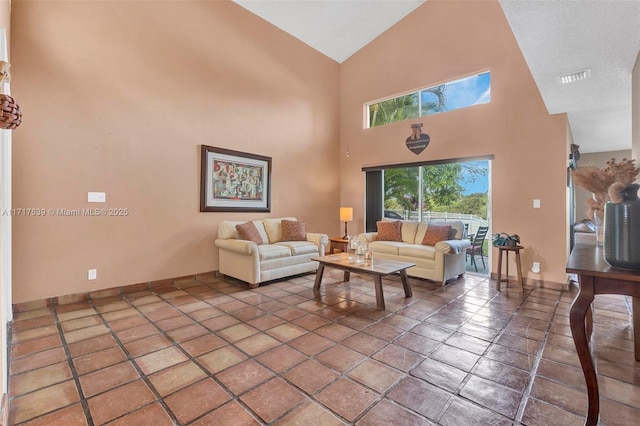 living room with tile patterned flooring and high vaulted ceiling