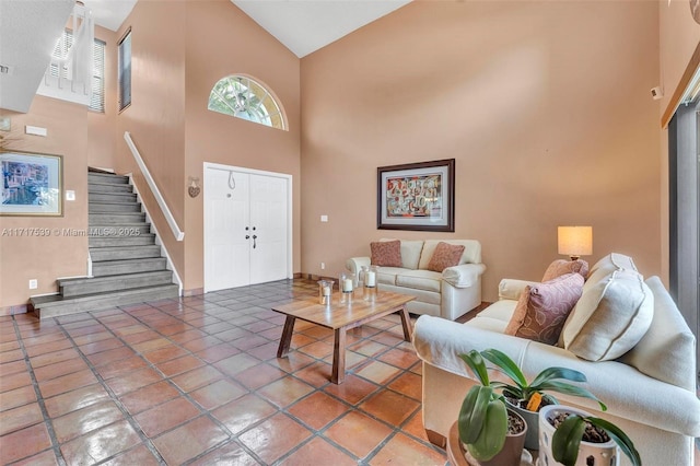 tiled living room featuring high vaulted ceiling