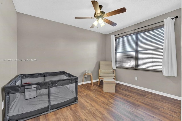 bedroom featuring ceiling fan and dark hardwood / wood-style flooring