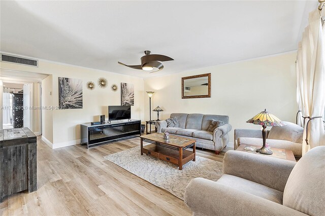 living room featuring ceiling fan, light hardwood / wood-style floors, and ornamental molding