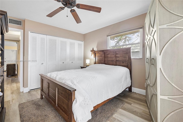 bedroom with ceiling fan, light hardwood / wood-style flooring, and a closet