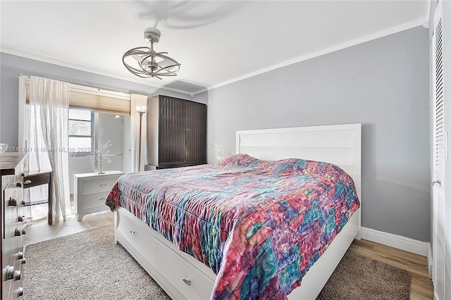 bedroom featuring hardwood / wood-style floors and crown molding