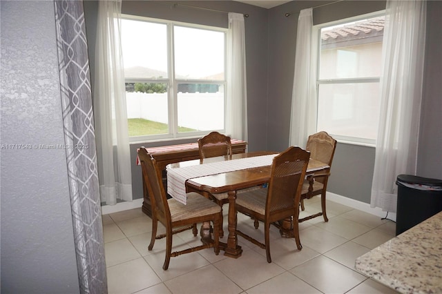 dining area featuring light tile patterned flooring