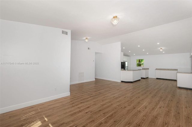 unfurnished living room with hardwood / wood-style flooring