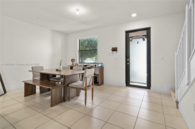 dining space featuring light tile patterned flooring