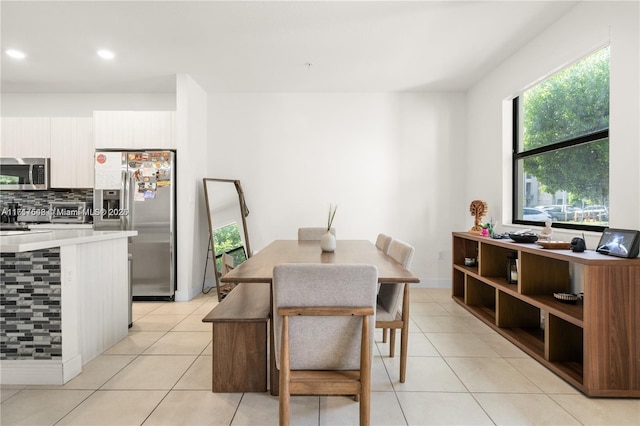 dining space featuring light tile patterned floors and recessed lighting