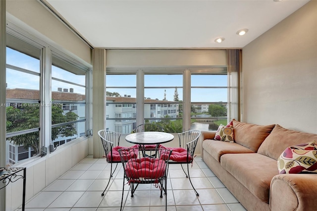 sunroom / solarium with plenty of natural light and a water view