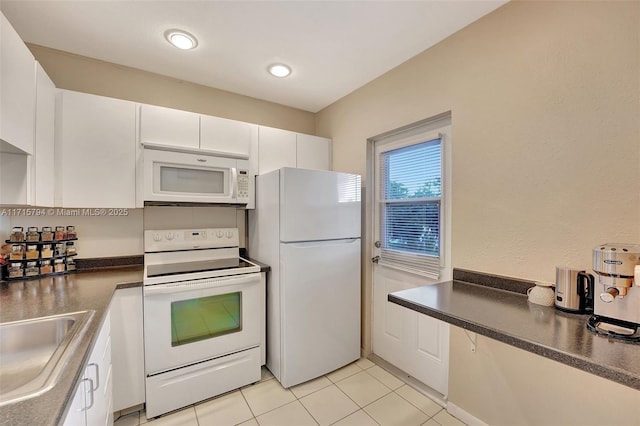 kitchen with white cabinetry, white appliances, sink, and light tile patterned floors