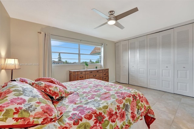 tiled bedroom with ceiling fan and a closet