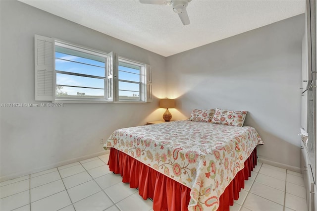 tiled bedroom featuring ceiling fan and a textured ceiling