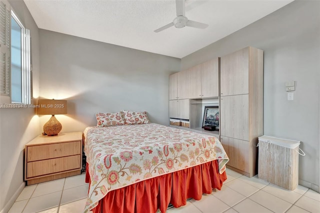 bedroom with ceiling fan and light tile patterned floors