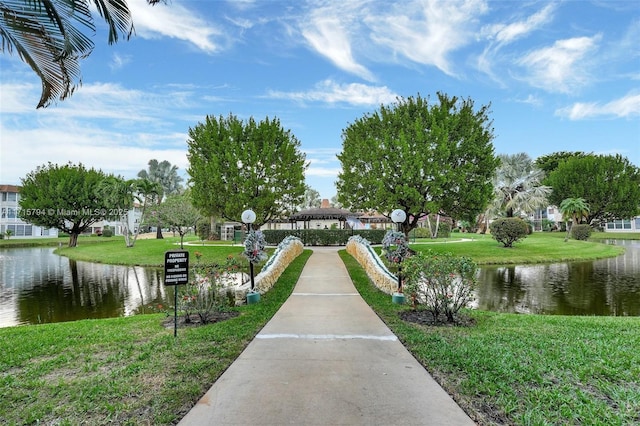 surrounding community featuring a water view and a yard