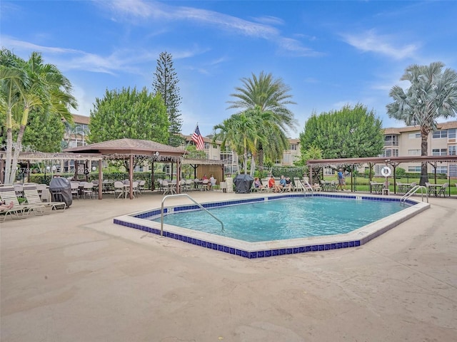 view of swimming pool with a gazebo and a patio area