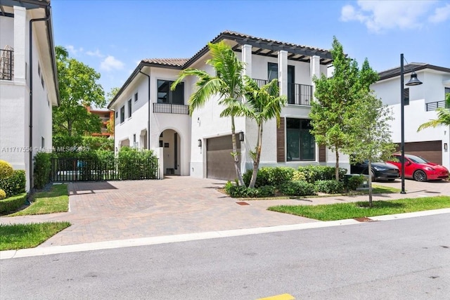 mediterranean / spanish-style home with a balcony and a garage