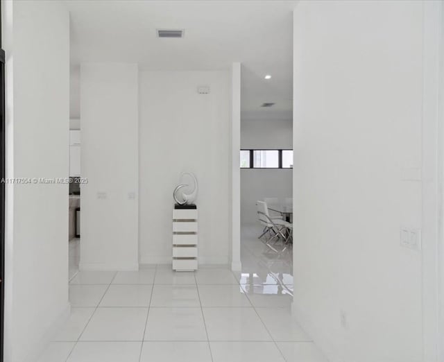 corridor featuring light tile patterned floors