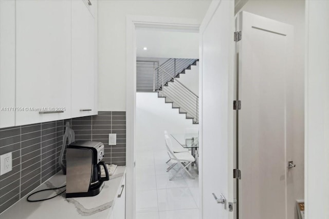 interior space featuring decorative backsplash and tile patterned flooring