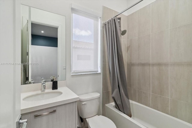 full bathroom with vanity, a healthy amount of sunlight, toilet, and shower / bathtub combination with curtain